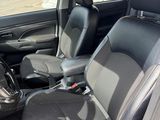the interior of a car with two seats and a steering wheel