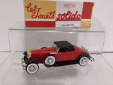 a red toy car in a clear display case