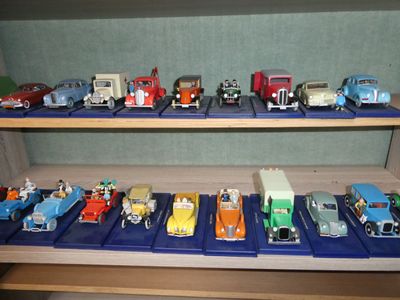 many toy cars that are on a shelf in a room