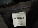 a close up of a black jacket with a label on it