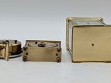 a small metal object that is sitting on a white surface