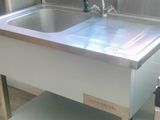 a stainless steel sink with a faucet in the middle