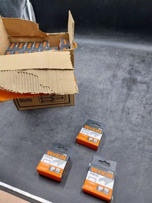 a box of orange batteries sitting on the floor next to a box of orange batteries