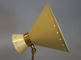 brass table lamp with a gold cone shade and stars on it
