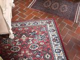 a rug on the floor next to a fireplace in a living room
