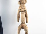 a woman that is standing next to a wooden statue