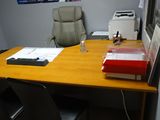 a desk with a chair and a printer on it