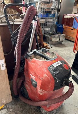 a red vacuum cleaner that is sitting on the floor