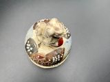 a small figurine of a dog sitting on top of a table