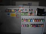 a display of soda cans on a shelf in a room