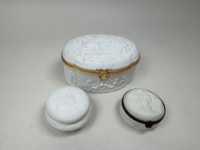 a small white box with a lid and two cookies