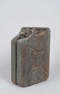 an old metal canister with a metal handle on a white background