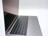 a silver laptop with a black keyboard on a white surface