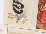 several vintage posters are displayed on a wall in a room