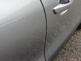 a close up of a car door handle with a sticker on it