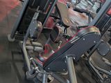 a gym with a row of machines in the middle of the room