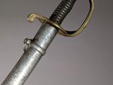 an old sword with a gold handle on a gray background