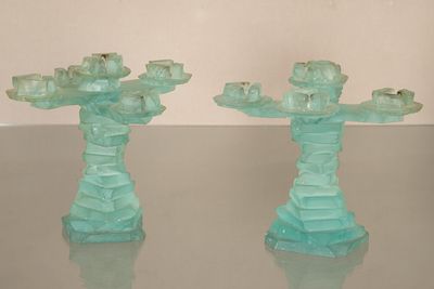 two glass candlesticks that are sitting on a table