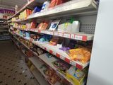 shelves in a grocery store filled with lots of different types of food