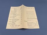 a menu for a restaurant on a blue table