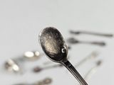 a silver spoon and some silver spoons on a table