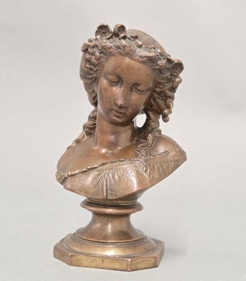an antique bronze bust of a woman on a pedestal