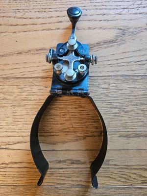a picture of a metal clamp on a wooden table