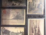 many pictures of old buildings on display in a window