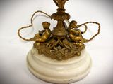 a white marble base with a gold statue on it