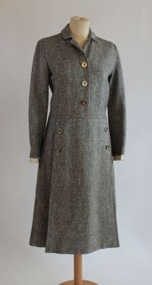 an image of a woman ' s coat on a mannequin stand