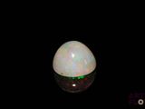 an image of a white oplite in the dark
