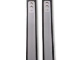 two black and white toothbrushes sitting next to each other on a white surface
