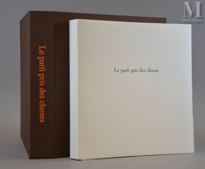 the book is open and sitting on the table next to the box