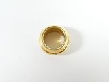 a close up of a gold colored object on a white surface