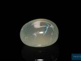 an image of a white jade stone on a black surface