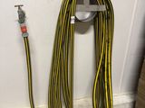 a yellow and black hose attached to a white wall