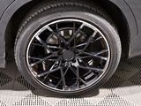 a close up of a black car with a black rim