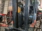 a forklift that is sitting in a warehouse