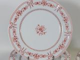 a stack of plates with red and white designs on them