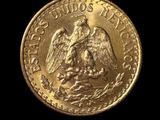 a close up of a gold coin on a black background