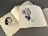 two open notebooks with drawings of a man and a woman on them