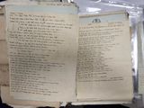 an old book with writing on it sitting on a table
