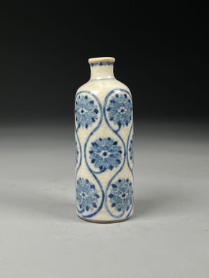 blue and white vase with a floral design on the outside