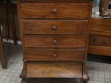 a wooden dresser with a mirror on top of it