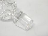 a clear glass bottle with a glass stopper on it