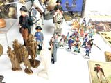 many figurines on a table with pictures on it
