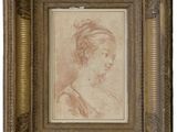 un dessin représentant la tête d'une femme dans un cadre doré