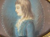 portrait of a woman in a blue dress in a gold oval frame