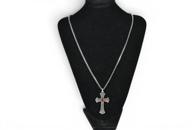 a necklace with a cross on it on a mannequin
