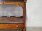 a small wooden table with a mirror on top of it